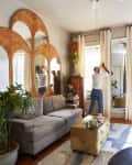 Light-filled living room with curved mirrors set in bamboo frames