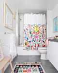 Bathroom with colorful rug and shower curtain