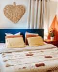 Bedroom with wicker heart above bed