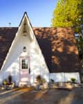 A-frame house with pink front door