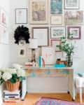 A decoupaged map on an IKEA desk. A gallery wall is hung above the work space.