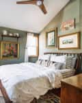 Green walls in a bedroom with a white ceiling and wood accents