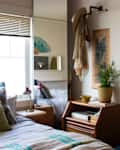 Vintage fabric used as wallpaper decorates a bedroom