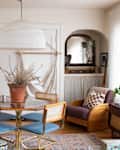 A light-filled living/dining room with a dining table and a paper-lantern pendant overhead