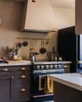 Beige kitchen with textured walls and deep blue cabinets and appliances