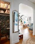 Entryway of apartment looking into various living spaces; including living room, kids playroom and small cloffice.