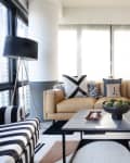 Modern living room with beige leather sofa, graphic black and white accents