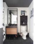 Bathroom with black floor, white walls, other black and white accents