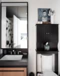 Bathroom with black and white accents, detail of sink and black cabinet