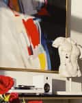 Abstract painting above a shelf with a white torso sculpture, red roses, and white speakers.