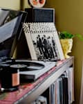 Vintage album displayed on credenza topped with record player.