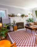 Eclectic living room with pops of color throughout and checkerboard rug on floor.