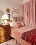 Pink bedroom in colorful Brooklyn apartment