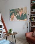 living room with blue loveseat, white walls, lots of plants, built-in shelves, art/photography on walls, wood art details