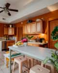 Rust painted kitchen with wooden cabinets.