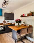 white kitchen with wood countertops and island
