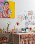 white home art studio and workspace with lots of supplies and finished creations around