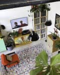 Living room with patterned carpet and red chair.