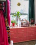 Pink dresser in colorful bedroom.