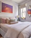 Neatly made bed in NYC apartment.
