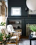 blue living room with brown leather couch and white paper lantern