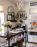 White kitchen with a wooden island and blue cabinets