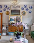 Living room with colorful furniture and blue and white china hanging on the wall