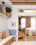 White multi-use space with art on walls and plants
