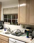 Kitchen cabinets before being professionally painted.