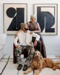 Couple with their dog on chair in living room