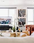 white living room with white sofa, black, neutral and white decor, and lots of curved edge furniture