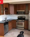 Kitchen with brown cabinets and chrome appliances