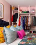 A bedroom with an open-face closet.