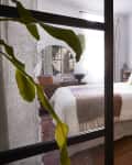 Look through glass doors into bedroom.