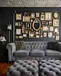 Gold frames line gallery wall in goth themed living room.