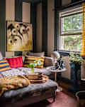 Striped wallpaper in eclectic living room.