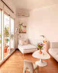 White living room with white sofa, pink accents, large windows
