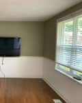 Empty living room with green walls and TV