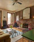 Window open in bricked walled apartment living room.