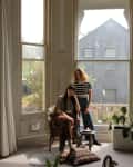 Couple posing in front of large bay window.