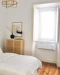 White minimal bedroom with wood and neutral tones