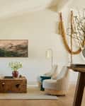 Yellow velvet couch, sculptural wood coffee table, white marble side table, white boucle accent chairs