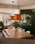 Pendants hanging over dining room table in open home.