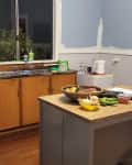 Pale blue kitchen with wood floor before remodel
