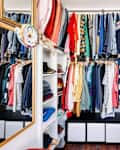 Clothing hangs in an exposed closet.