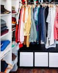 Clothing hangs in an exposed closet.