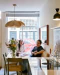 Couple sitting at dining table in Amsterdam apartment.