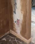 Walls under staircase and around doorway before being painted.