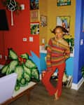 Woman standing in living room space with colorful walls