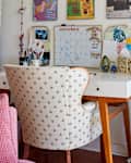 white desk with calendar and lots of colorful art and accessories
